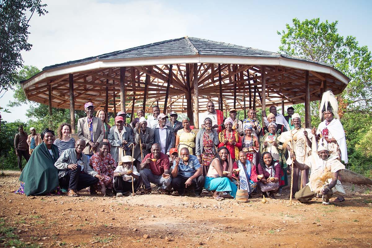Community members stand with Simon (back row, center) in front of the newly constructed Gaaru in Tharaka. Photo: Rory Sheldon